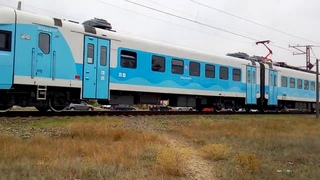 Электропоезд ЭП2Д-0119 в пасмурную погоду следует по ул.Короленко Евапатория.