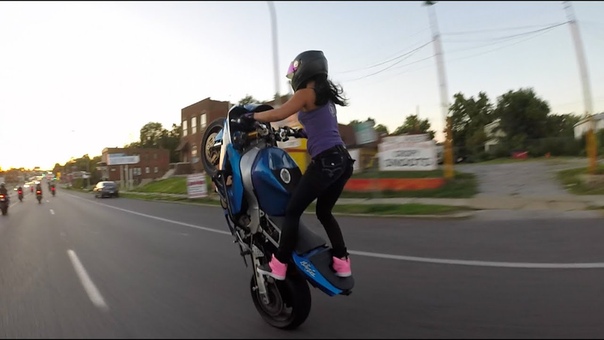 Crazy girl does motorcycle stunts on St. Louis streets